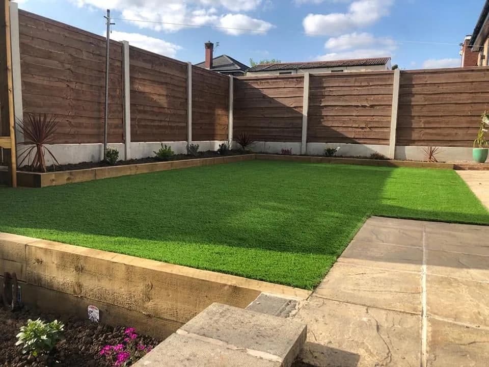 Completed garden with artificial lawn, paved path and raised decking